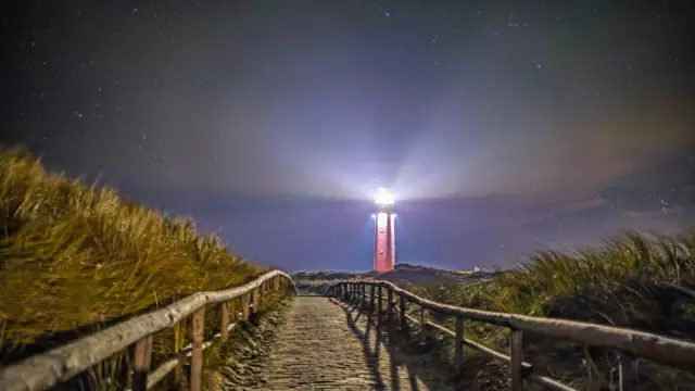 Vuurtoren met licht in de nacht